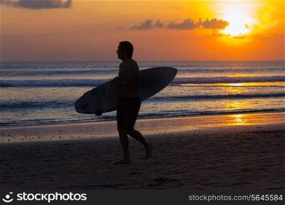 Surfer Watching the Waves at Sunset.
