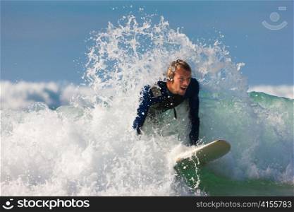 Surfer with his board in the wild waves