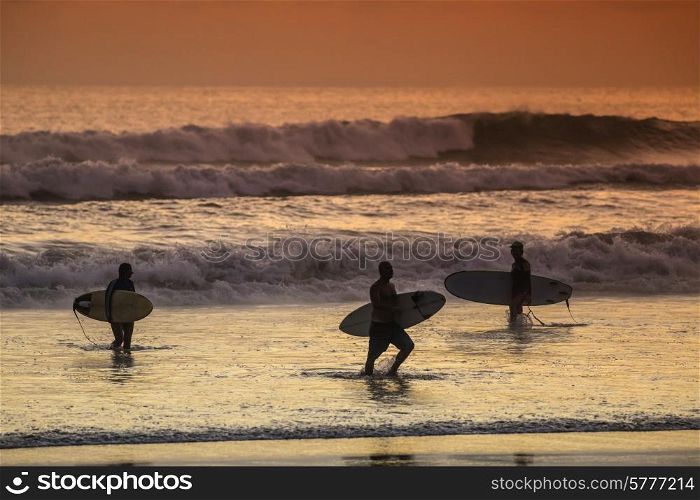 Surfers on the Beach at Sunset Tme, Bali, Indonesia