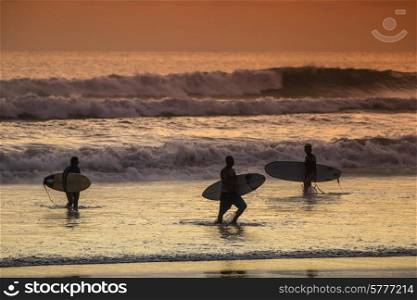 Surfers on the Beach at Sunset Tme, Bali, Indonesia