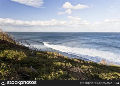 Surfers riding the waves at Bells Beach, Great Ocean Road, Australia, on a cold winter day