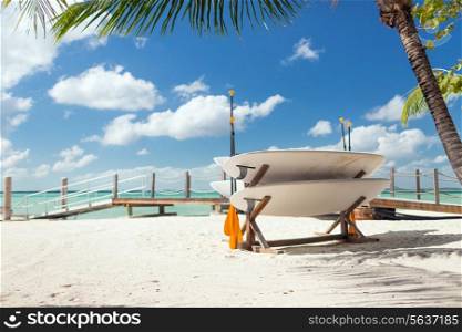 surfing, beach, summer and leisure concept - surfboards on tropical beach
