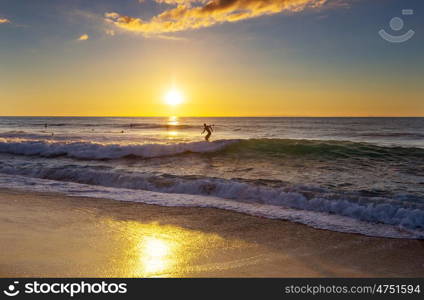 Surfing. Hawaiian surfing beach at sunset