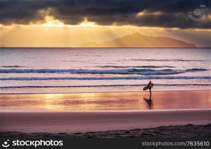 Surfing scene in New Zealand coast, sunrise time