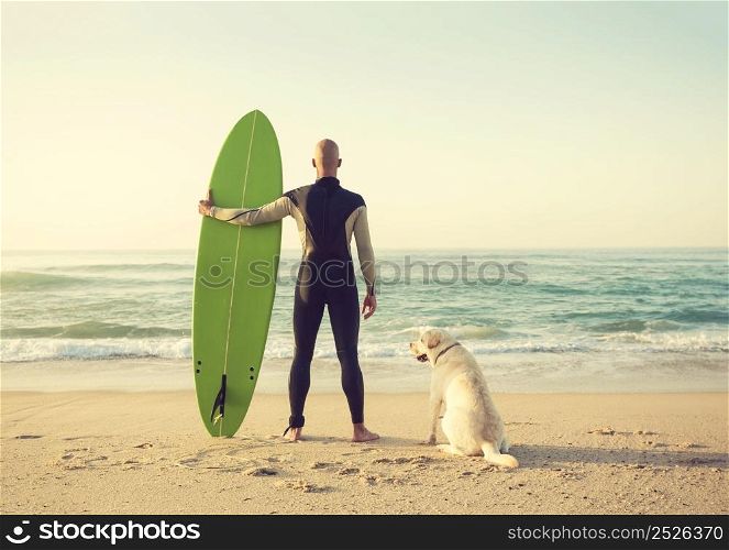 Surfist on the beach with his best friend