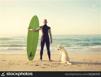 Surfist on the beach with his best friend