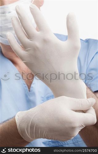 Surgeon adjusting his surgical gloves