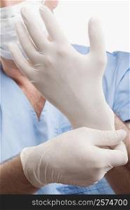 Surgeon adjusting his surgical gloves