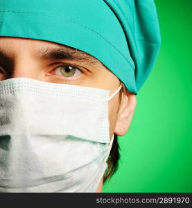 Surgeon in mask over green