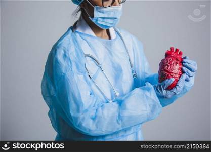 surgeon posing with heart