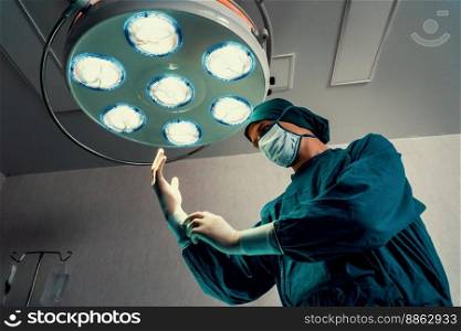 Surgeon put on protective surgical sterile gloves and mask as preparation before perform surgical operation in the surgery room. Surgery preparation concept for medical use.. Surgeon put on protective surgical sterile glove and mask before perform surgery