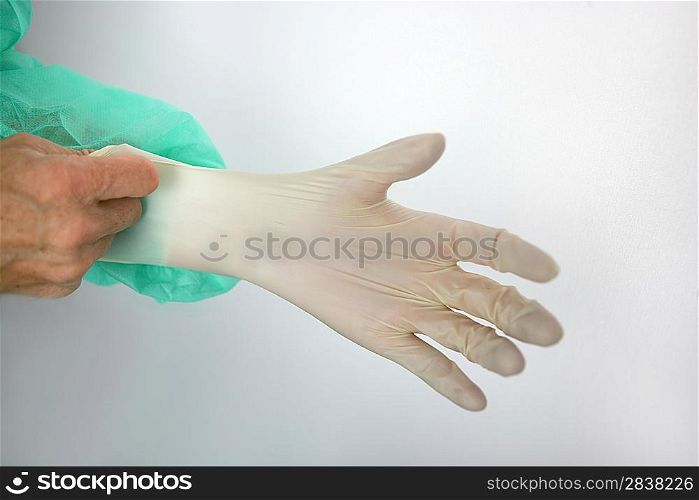 Surgeon putting on a rubber glove
