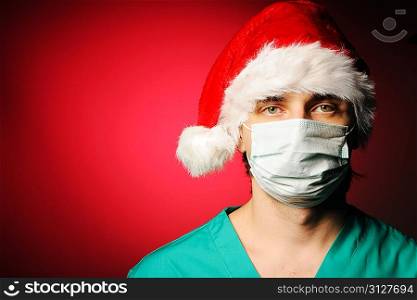 Surgeon with mask in Santa&acute;s hat