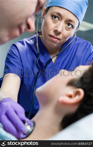 Surgeons checking patient
