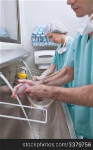 Surgeons washing hands after operation