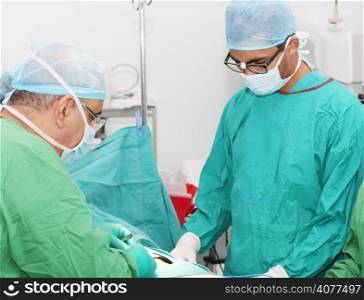 Surgeons working in operation room