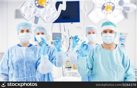 surgery, medicine and people concept - group of surgeons in operating, room at hospital. group of surgeons in operating room at hospital. group of surgeons in operating room at hospital