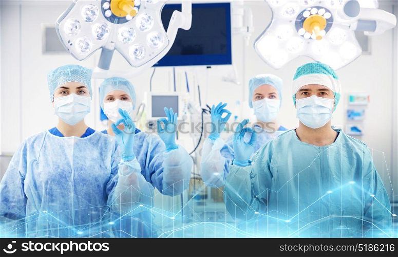surgery, medicine and people concept - group of surgeons in operating, room at hospital. group of surgeons in operating room at hospital