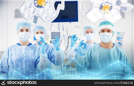 surgery, medicine and people concept - group of surgeons in operating, room at hospital. group of surgeons in operating room at hospital