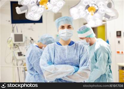 surgery, medicine and people concept - surgeon in operating room at hospital