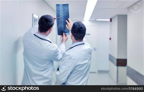 surgery, people, healthcare and medicine concept - medics with spine x-ray scan at hospital. medics with spine x-ray scan at hospital