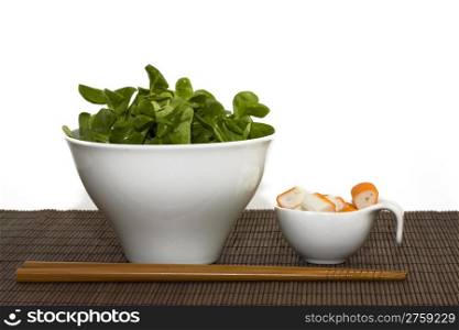 surimi and salad. a background photo of a cup of salad and surimi