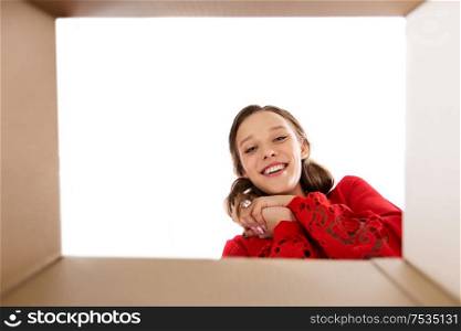 surprise, delivery and holidays concept - happy young woman looking into open gift box. happy young woman looking into open gift box