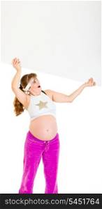 Surprised beautiful pregnant woman holding blank billboard over her head isolated on white&#xA;
