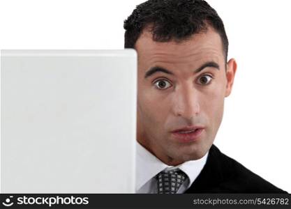 Surprised businessman at a laptop