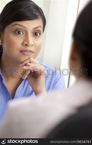 Surprised businesswoman listening to female executive