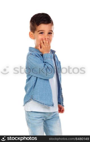 Surprised child covering his mouth isolated on a white background