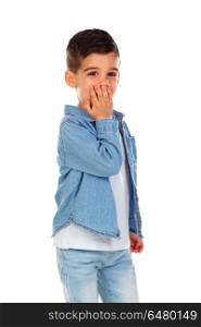 Surprised child covering his mouth isolated on a white background