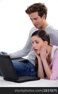 Surprised couple with a laptop