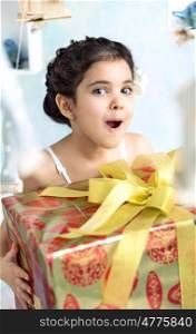 Surprised cute girl with birthday gifts
