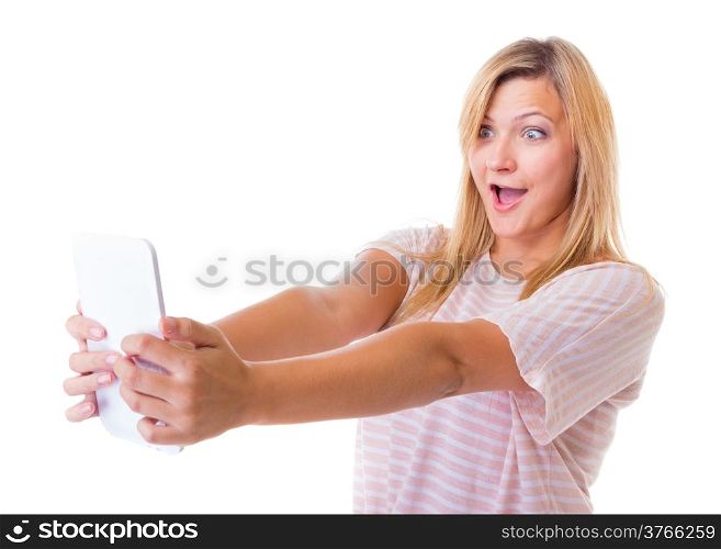 Surprised emotional young woman using tablet touchpad. Blond shocked girl reading e-book e-reader isolated. Technology.