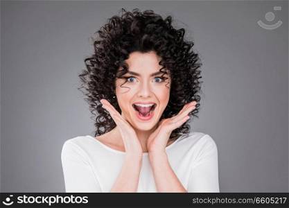 Surprised excited beautiful woman screaming amazed in joy. Woman screaming amazed in joy