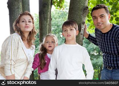 surprised family of four outdoors