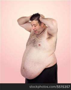 Surprised fat man isolated on a pink background
