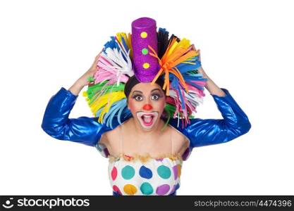 Surprised girl clown with a big colorful wig isolated on white background
