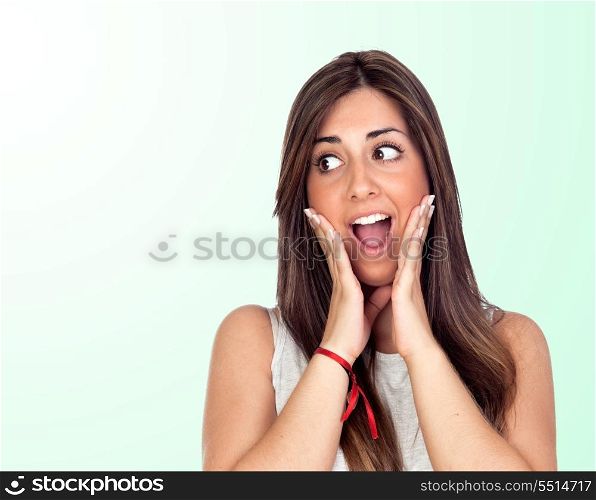 Surprised girl with long hair isolated on green background