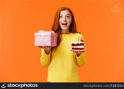 Surprised happy and amused cheerful redhead b-day girl celebrating her birthday receive presents and sweets, look amused and dreamy, gasping excited, holding wrapped pink box with gift, birthday cake.. Surprised happy and amused cheerful redhead b-day girl celebrating her birthday receive presents and sweets, look amused and dreamy, gasping excited, holding wrapped pink box with gift, birthday cake