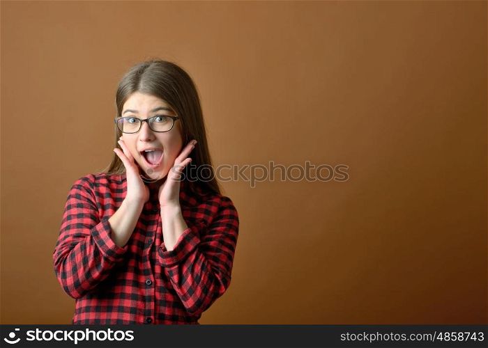 Surprised happy teen girl in studio