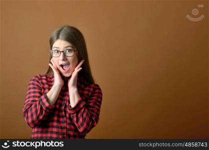 Surprised happy teen girl in studio