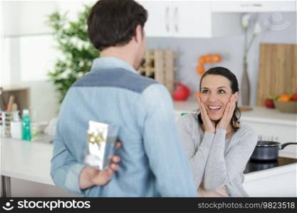 surprised happy woman is about to receive a birthday gift