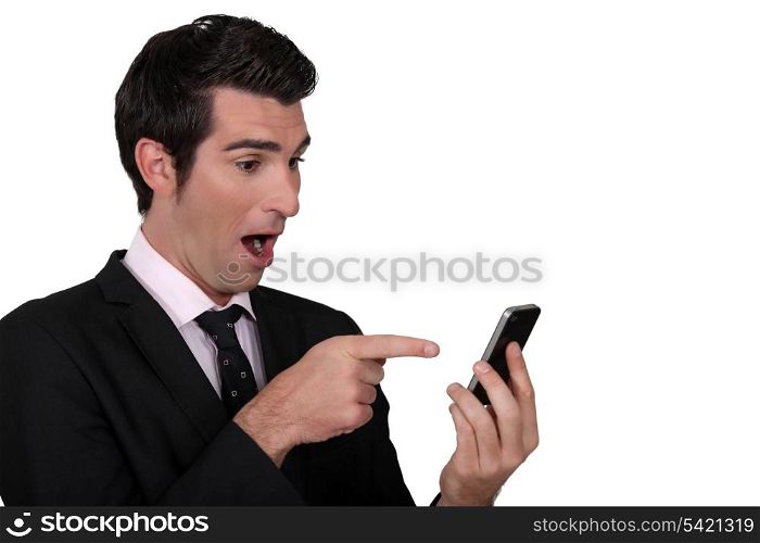 Surprised man pointing to his mobile phone