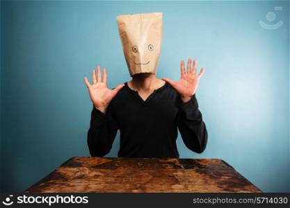 Surprised man with paper bag over his head