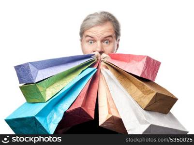 surprised mature man holding shopping bags near face isolated on white background