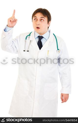Surprised medical doctor with rised finger isolated on white. Idea gesture&#xA;