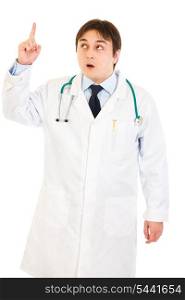 Surprised medical doctor with rised finger isolated on white. Idea gesture&#xA;
