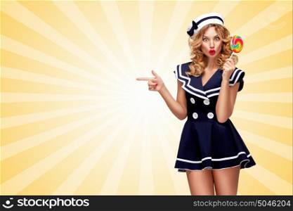 Surprised pin-up sailor girl with a lollipop pointing aside on cartoon style background.